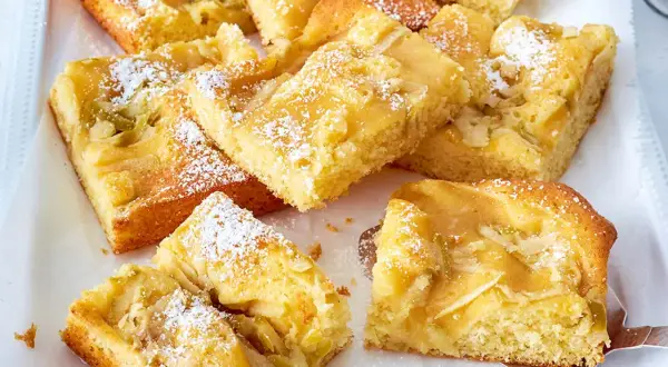 Saftiger Apfelkuchen mit Apfelmus, bestäubt mit Puderzucker. Ein köstlicher Genuss für jeden Anlass.